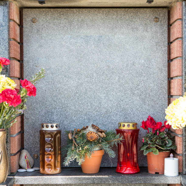 istock People remembering their loved ones who died; on the cemetery 1187208584