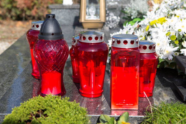 istock People remembering their loved ones who died; on the cemetery 1187208618