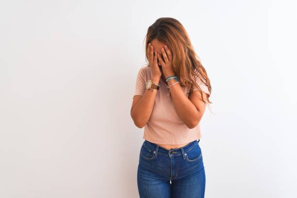 istock Young redhead woman stading over white isolated background with sad expression covering face with hands while crying. Depression concept. 1187208944