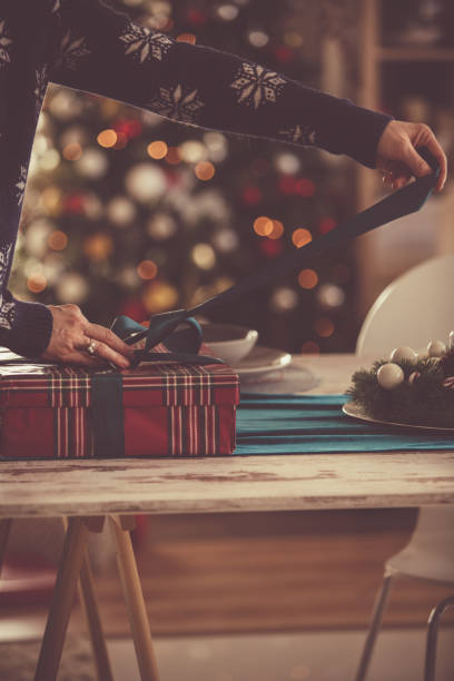 istock Woman wrapping a Christmas present 1187209306