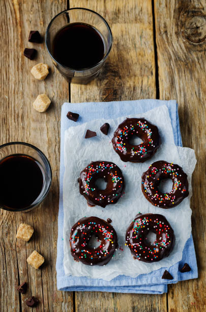 istock Baked chocolate doughnuts with chocolate glaze and coffee drink 1187210979