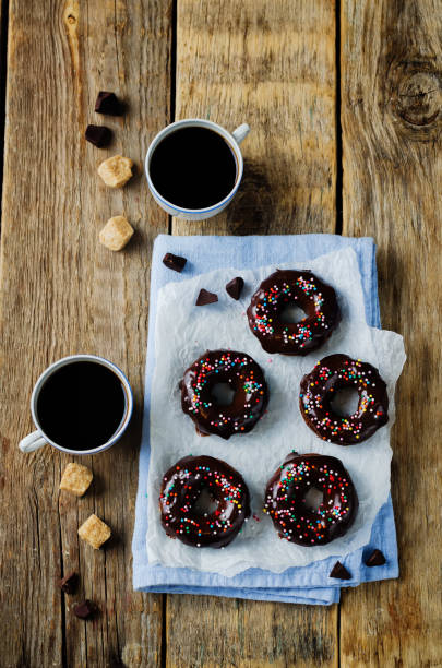 istock Baked chocolate doughnuts with chocolate glaze and coffee drink 1187210988