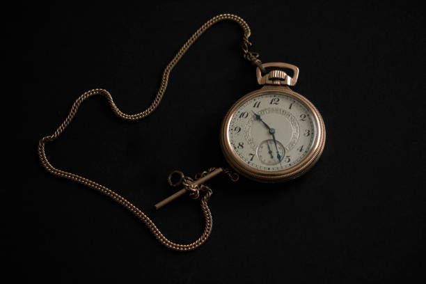 istock Gold Pocket Watch and Chain on Black Background 1187211323