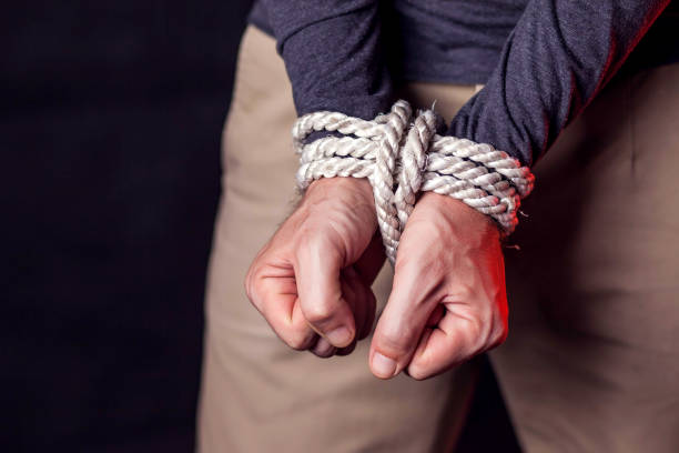 istock Man with bound hands. People violence and criminal concept 1187212462