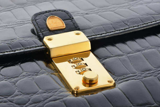 istock Gold lock combination on black leather bag. Luxury accessories 1187213222