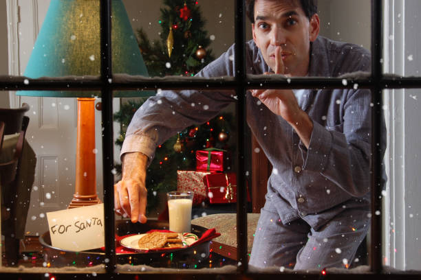 istock Father Stealing a Cookie Set Out For Santa Claus 1187215648