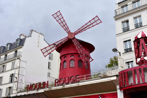 Famous Moulin Rouge cabaret. Paris, France. Paris. France. August 18, 2018. View of the famous Moulin Rouge with the red windmill, located at Boulevard de Clichy, Pigalle district, close to Montmartre neighbourhood. vintage of burlesque dancers stock pictures, royalty-free photos & images