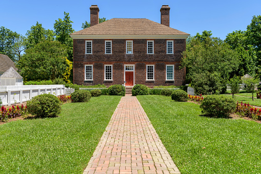 Williamsburg, Virginia, USA - June 11, 2019: A sunny Spring day view of the 18-century historic George Wythe House, seen from its back garden, in Colonial Williamsburg.