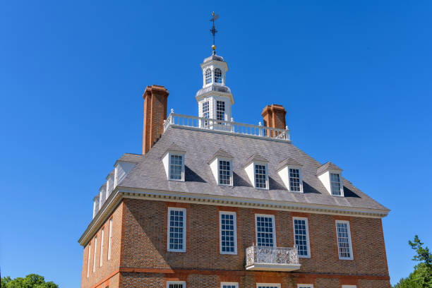 Governor's Palace - A close-up view of the upper facade and bell tower of the historic Governor's Palace in Colonial Williamsburg, Williamsburg, Virginia, USA. Williamsburg, Virginia, USA - June 11, 2019: A close-up view of upper facade and bell tower of the Governor's Palace, the home for the Royal Governors and the first two elected governors of Virginia. governor's palace williamsburg stock pictures, royalty-free photos & images