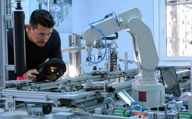 Man is programming robotic arm stock photo