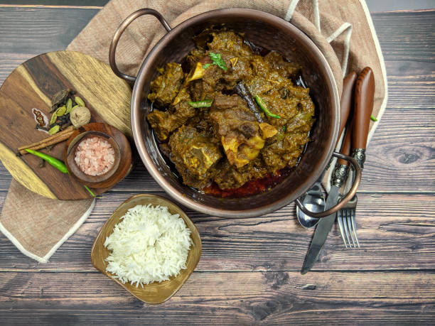 istock Overhead view of Goat curry, Mutton curry, Nihari, Rogan Josh in a bowl with Chapati and plain Rice. 1187226795