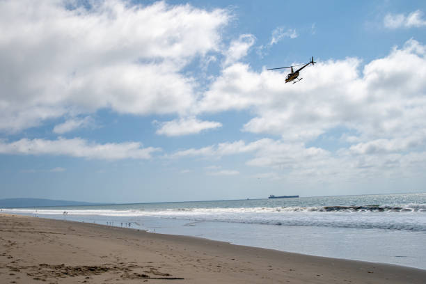 istock Helicopter patrols over the ocean beach 1187227491