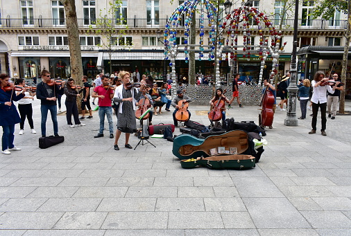 Paris, France. August 16, 2019. An small orchestra perfoms classical music on the street close to the Louvre Museum, in front of the Palais Royal.