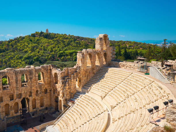 istock Panoramic image of ancient Greek theatre under Acropolis hill in Athens, Greece. Sunlit empty amphitheater on a sunny day with blue sky. 1187230416