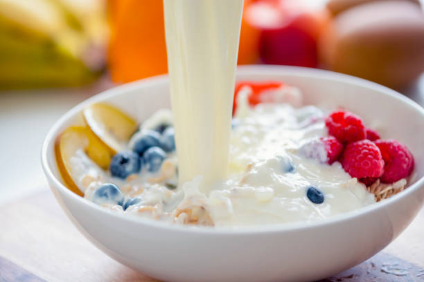 istock Pouring milk on a Healthy breakfast with fruit. 1187232808