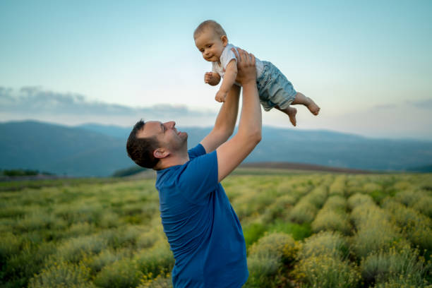 istock Family time. The father holds a small son. Spring walk 1187234286