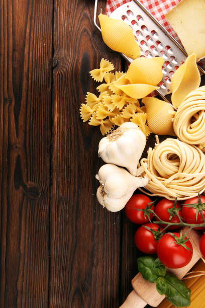istock Pasta, vegetables, herbs and spices for Italian food on rustic table 1187237691