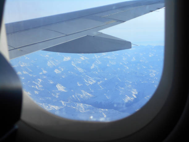 istock View through the plane window, as the plane flies high above the clouds 1187238631