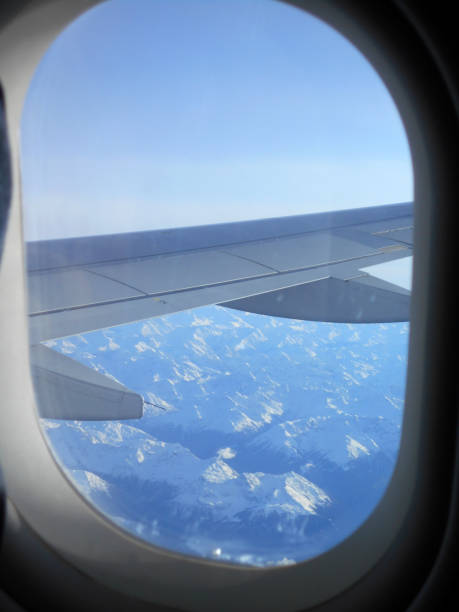 istock View through the plane window, as the plane flies high above the clouds 1187238634
