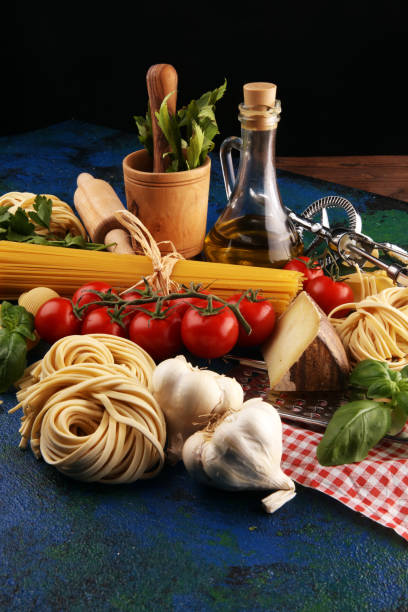 istock Pasta, vegetables, herbs and spices for Italian food on rustic table 1187239736