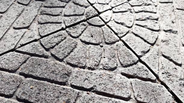 istock old stone tiled floor with round pattern on a sunny street, review. 1187245527