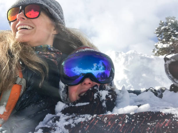 istock Mother and son crashing into the snow while sledding 1187245704