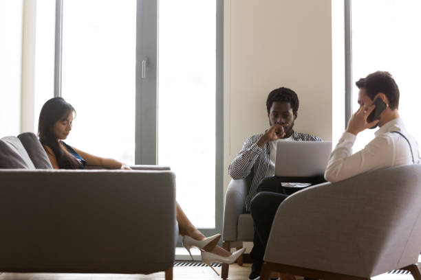 istock Busy diverse business people using devices, working online in office 1187245840