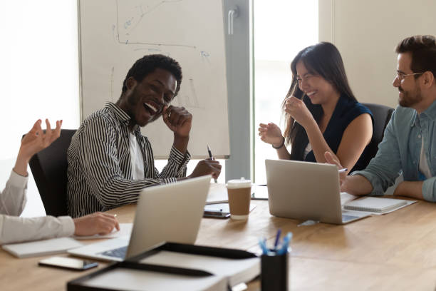 istock Diverse employees team having fun at meeting in boardroom 1187245844