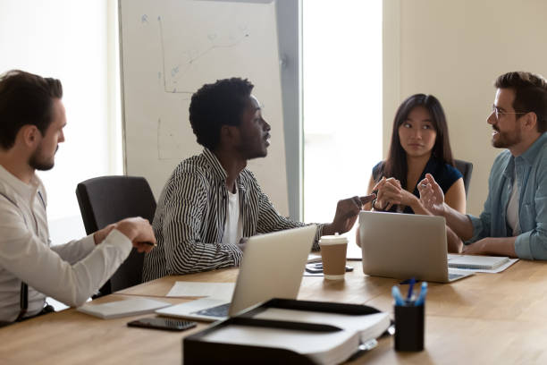 istock Diverse employees team discussing project at briefing in boardroom 1187245846