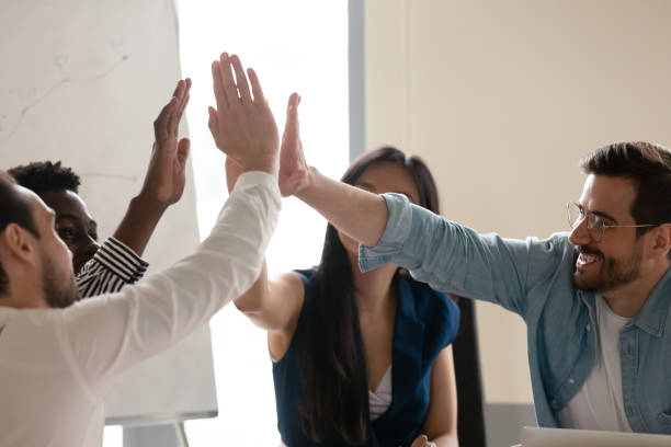 istock Diverse employees giving high five at meeting, celebrating success 1187245864