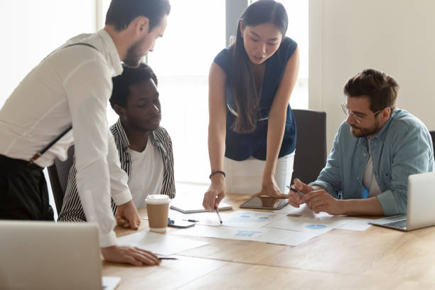 istock Diverse employees discussing statistics, project results at meeting 1187245867