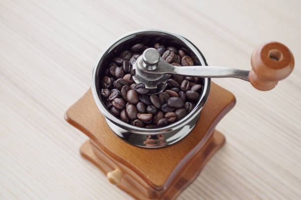 istock Vintage manual coffee grinder with roasted coffee beans 1187246130