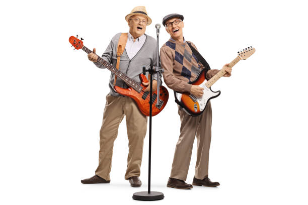 istock Two elderly gentlemen playing guitars and singing on a microphone 1187248777