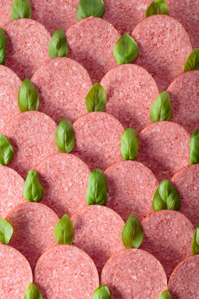 istock Sliced smoked sausage with green basil leaves. 1187248916