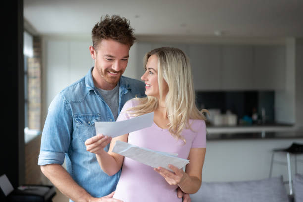 istock Happy couple at home checking the mail 1187250845