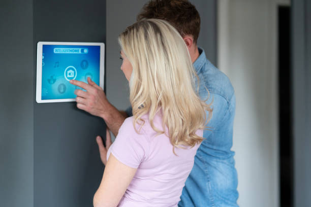 istock Couple controlling their intelligent home using app on a digital tablet 1187250923