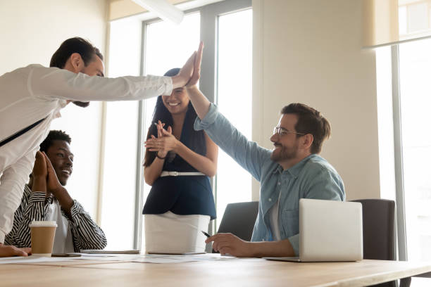 istock Happy colleagues giving high five at briefing, celebrating teamwork success 1187251833