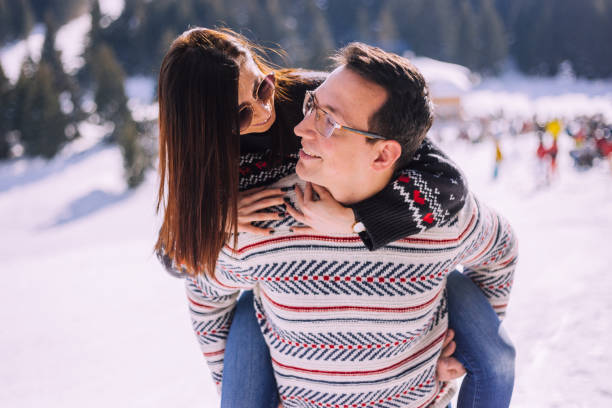 istock Young couple having fun on the snowy mountain 1187251874