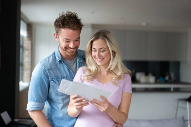 Loving couple checking their mail and looking happy