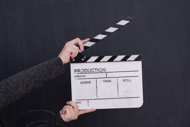 istock movie clapper on black chalkboard background 1187254528