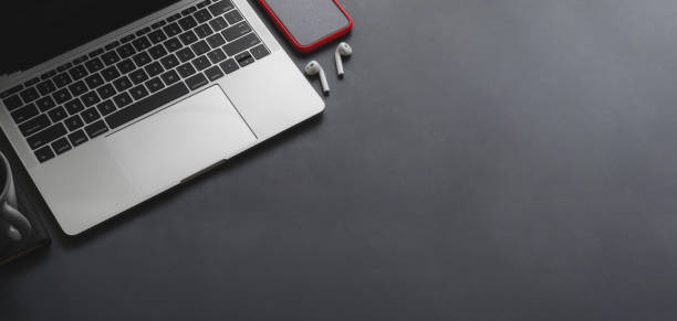 istock Overhead shot of laptop computer and smartphone with copy space on black table 1187258433