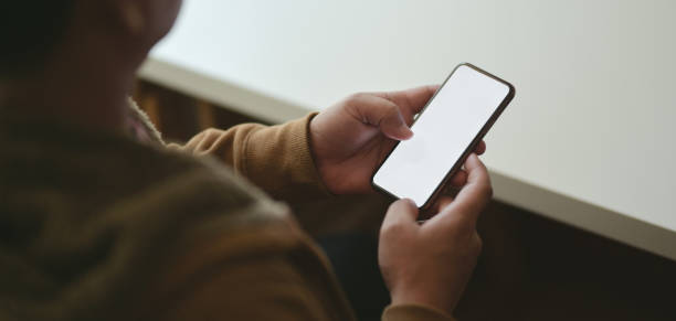 istock Cropped shot of man using blank screen smartphone in his modern workplace 1187258532