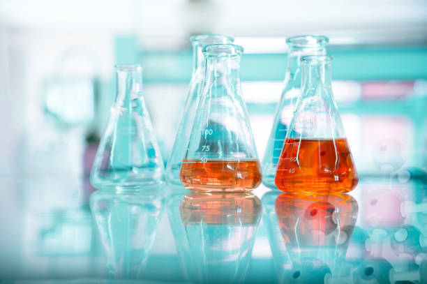 istock orange solution in glass flask at chemical green science and technology research laboratory background 1187262688