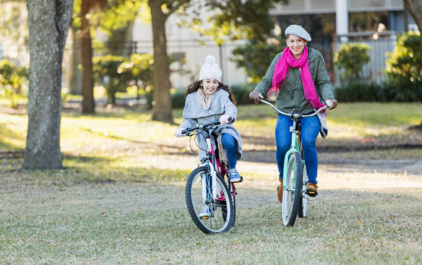 istock Hispanic mother and daughter on bicycles 1187262929