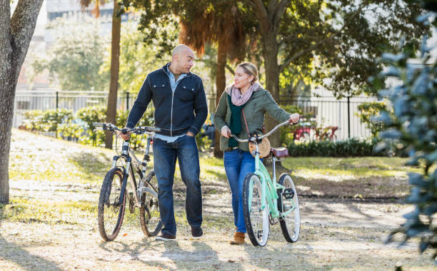 istock Hispanic couple in the park, riding bicycles 1187263537