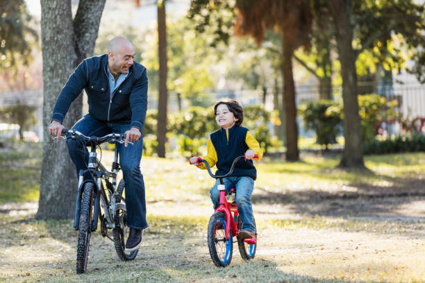 istock Hispanic father and son riding bicycles 1187263610