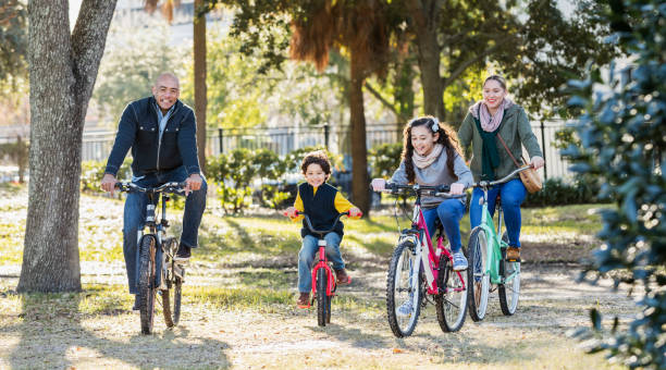 istock Hispanic family with two children riding bikes 1187263686
