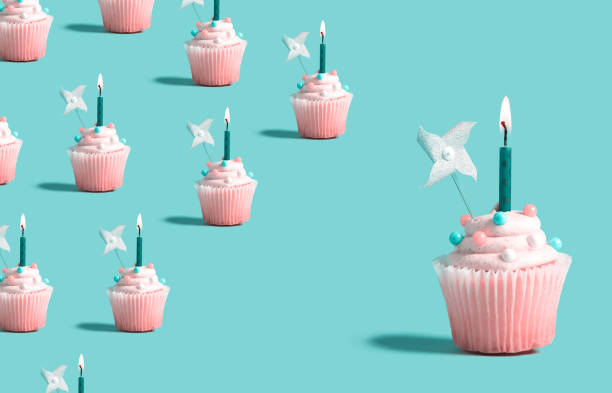 istock Big and small cupcakes with lit candles 1187264766