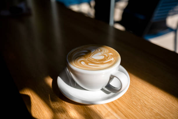 istock Cup of aromatic coffee with a pattern on the foam 1187265085