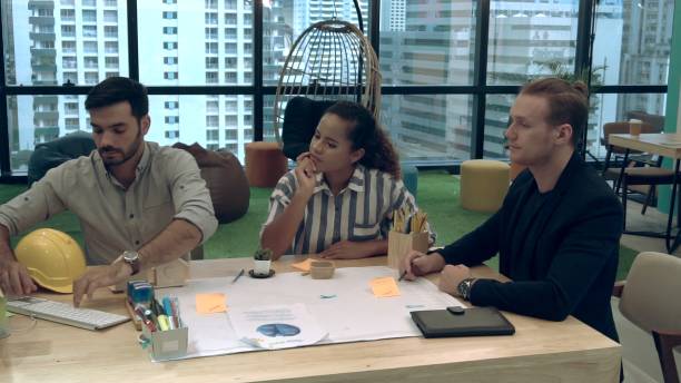 istock Creative business people group having conversation at office desk in workplace. 1187267049